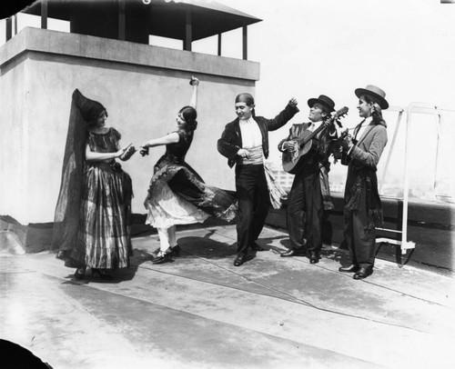 Dancers and musicians on rooftop, view 1