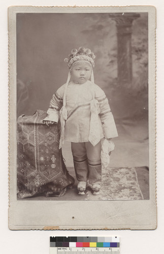Smith portrait of single child holding a tissue