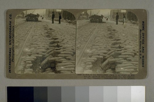 A Rift in the Earth--Deep crack in pavement on Mission Street, showing half buried street car, San Francisco, Cal [California], Disaster. 1906