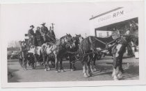 Bohnett family members in four-horse stagecoach in front of Standard Oil Station