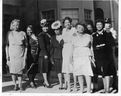 Group photograph of women standing in front of building