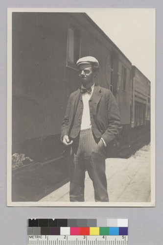 Roland L. Oliver standing in front of railroad car. [photographic print]