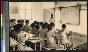 Classroom of boys and their African teacher, Congo, ca.1920-1940