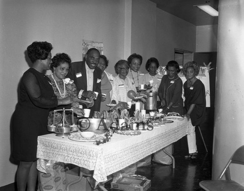 Men and women at serving table, Los Angeles, 1970