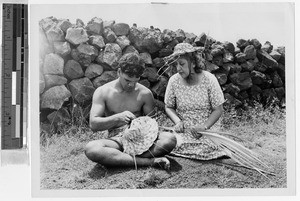 Man weaving a coconut palm hat, Hawaii, ca. 1949
