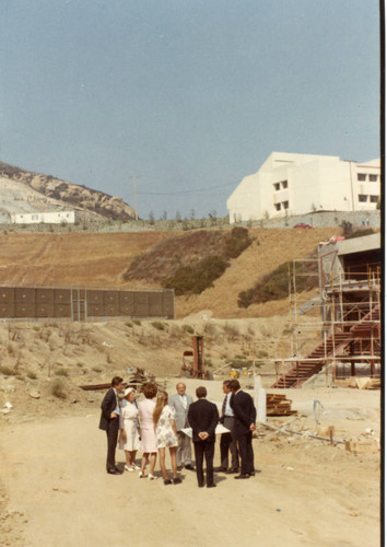 The Group standing on the site for the Pool; the Seaver College Campus in the backg round