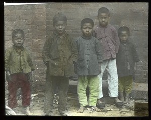 Five Chinese boys standing in front of a brick building, China, ca. 1920-1940