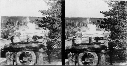 Pres. and Mrs. Harding in Yellowstone Park car, Supt. Albright of Yellowstone Park on right watching Grand Geyser, Yellowstone Park