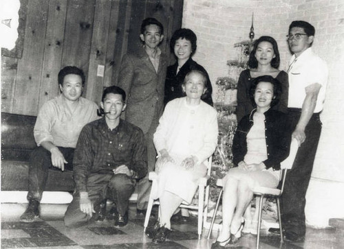 Ko Po Kwok sitting with her children at Christmas, Esther is to her right