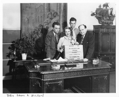 Canning and Preserving Industry and Trade - Stockton: Tillie Weisberg Lewis, her husband, and two unidentified men celebrating the millionth case of tomato products made at her plant, Flotill Products Inc., Fresno corner S. Ave