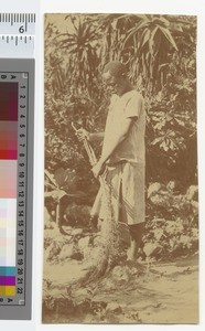 A young boy sweeping the road, Malawi, ca.1910
