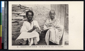 Two men sharing tobacco in the street, Ethiopia, ca.1900-1930