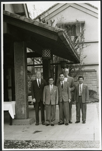 Charles Protzman standing with a group of men
