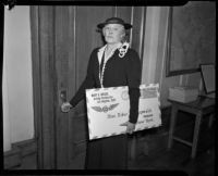 Postmistress Mary D. Briggs holding a giant envelope, Los Angeles, 1936