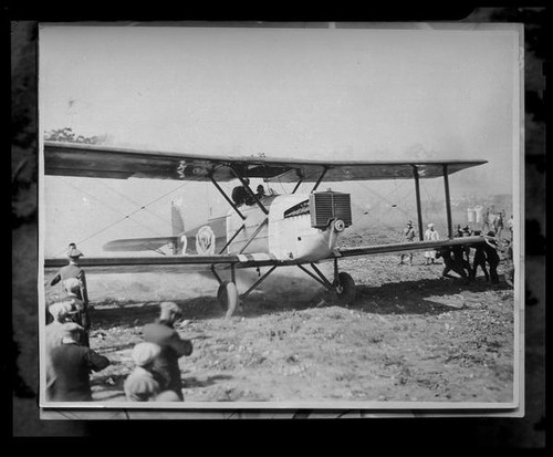 Biplane and uniformed men, [1920s?]