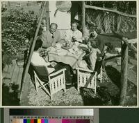 Five people seated at an outdoor table