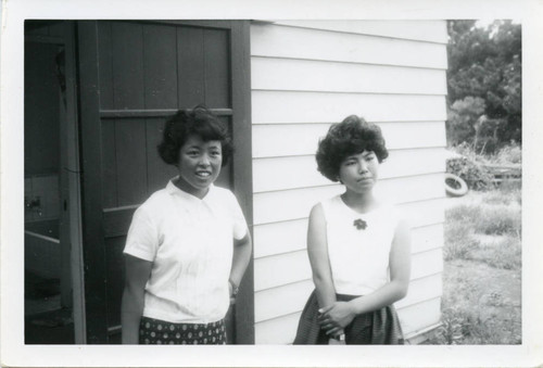 Two students in front of a duplex