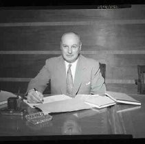 Unidentified man seated at a desk