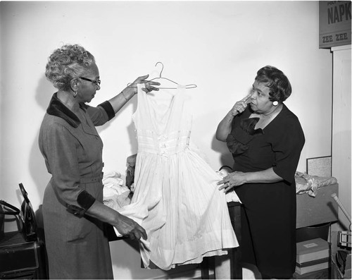 Woman hold garment, Los Angeles, 1963