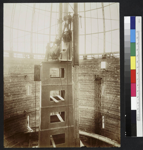 Construction of the piling base of the 40-inch telescope at Yerkes Observatory, with construction workers on top