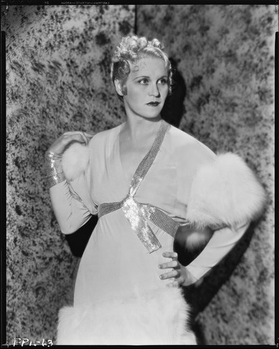 Peggy Hamilton modeling a chiffon gown with empire waist and fur trim, 1933