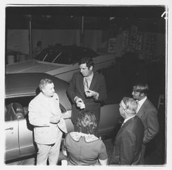 Ed Zumwalt talks to a group of people at the Zumwalt Chrysler-Plymouth Center Open House, Santa Rosa, California, 1971