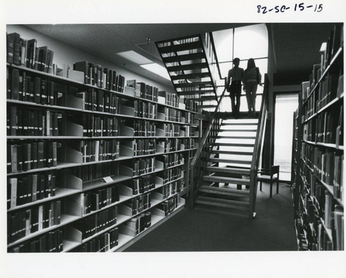 Students descending stairs in Payson Library, 1982