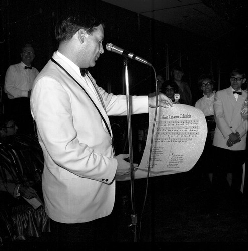 Unidentified man with scroll at the UCSD Faculty Ball. April 25, 1970