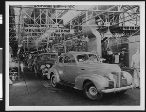 Interior of an automobile factory with assembly line, ca.1939
