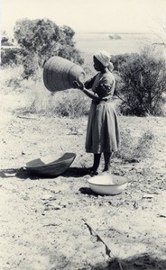 A young girl faning the grain