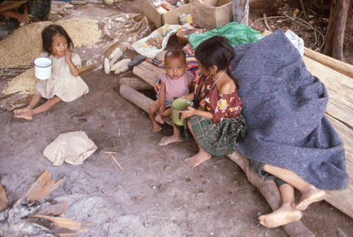 Guatemalan refugees eat and rest, Chajul, ca. 1983