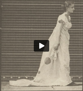 Woman in long dress stooping and lifting a handkerchief