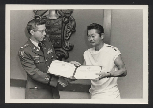 Suenari Koyasako receiving a certificate from the Department of Army