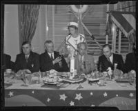 Ray H. Talbot, Charles H. Hunt, George W. Braden, and Ivan HIll enjoy dinner with a costumed Frances Dixon, Long Beach, 1936