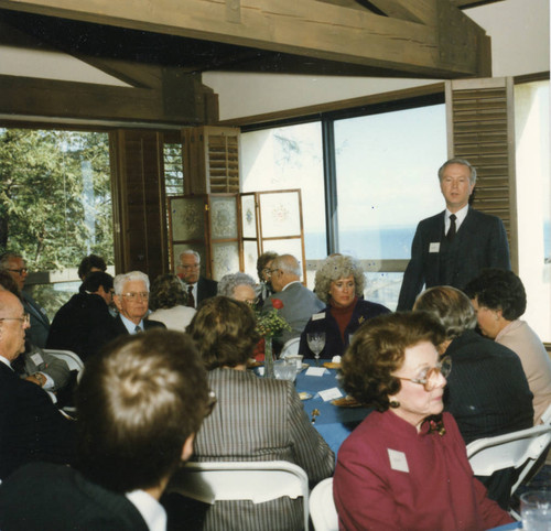 Dean Ron Phillips standing with people at tables (Color)
