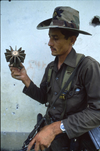 Contra soldier holds dormant landmine, Honduras, 1983