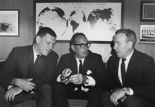 William A. Nierenberg, center, SIO Director and the Deep Sea Drilling Project's Principal Investigator, holds a core sample presented to him by Project Manager Kenneth E. Brunot, seated at left. Project Engineer Darrell L. Sims is at the right. August 19, 1968