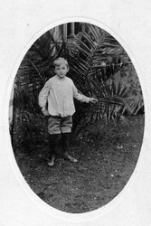 Oval photo of unidentified young boy in knee pants and white shirt, about 1890s