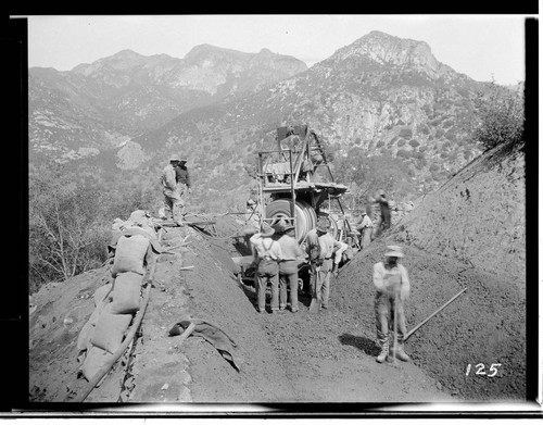 A construction crew using an electric powered mixer to prepare the concrete to line the ditch which will carry water to Kaweah #3 Hydro Plant