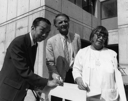 A ceremony at Cathay Manor, from left to right are Lewis Au, Ed Edelman and Lily Chan