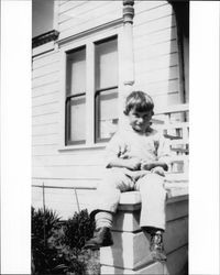 Tom Agius sitting on the steps at 210 West Street, Petaluma, California, about 1929