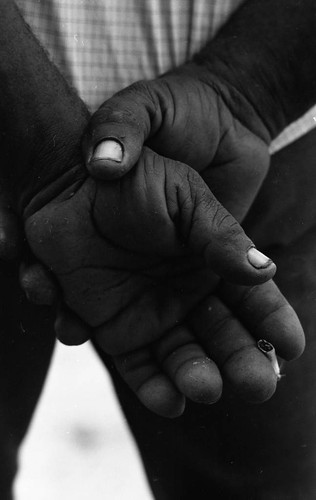Man's hands holding a cigarette, San Basilio de Palenque, 1976
