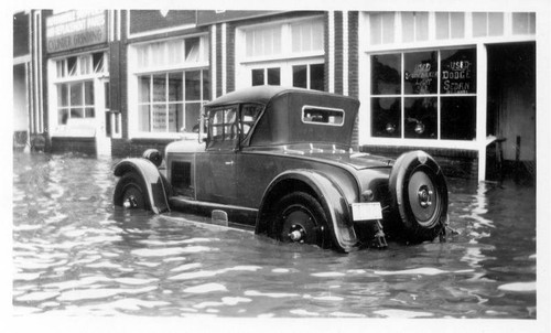 Car in front of flooded mechanic