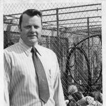 Tom Hoover, with dogs in a cage in the background. He was an animal control  officer for the City of Sacramento — Calisphere