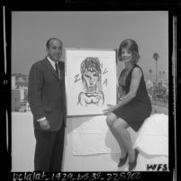 Author Henry Miller and actress Ziva Rodan with portrait of herself painted by Miller, 1964