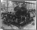 Steam plant workers assembling turbines, tending boilers, and adjusting pressure controls in a Steam Power Plant