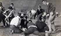 Stanford University students tussling on field