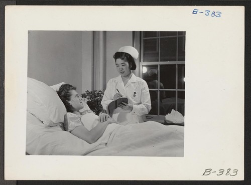 Miss Masako Takayoshi attending a patient in the Colorado General Hospital, where she is employed as assistant head nurse in