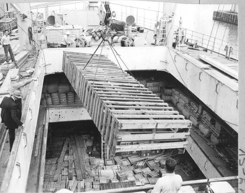 Long crate being lowered into hold