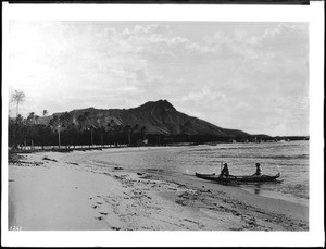 An outrigger canoe pulling up to the beach, Hawaii